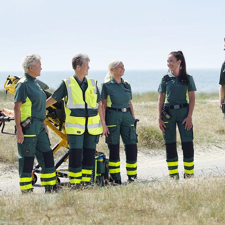 Ambulance professionals wearing green workwear
